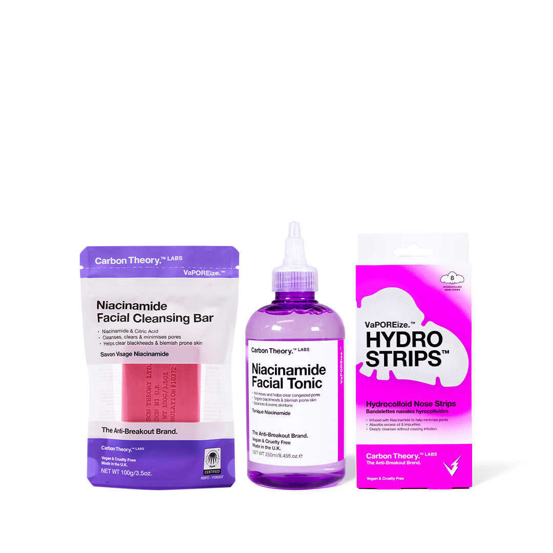 A pore repair kit by Carbon Theory, including a niacinamide cleansing bar, facial tonic, and hydro nose strips, packaged in a purple and white branded kit.
